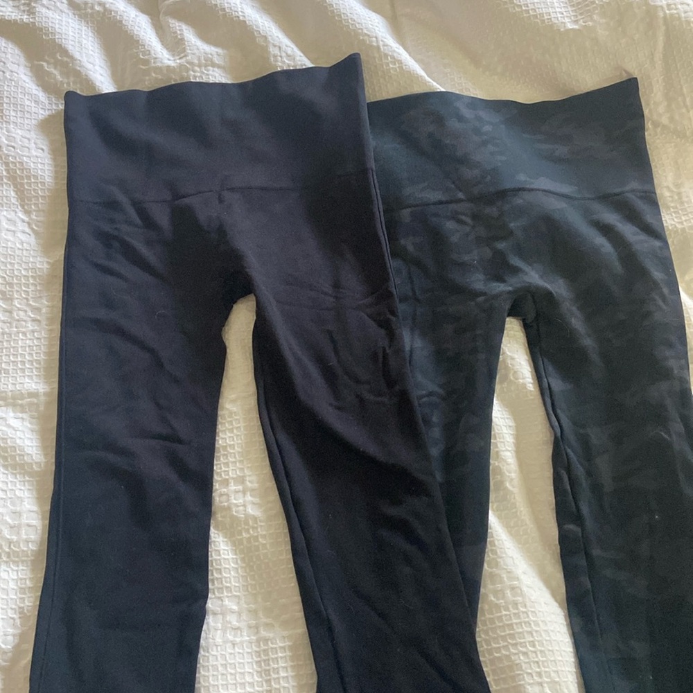 Two pairs of Spanx Leggings - Black and Black Camo. Size medium.